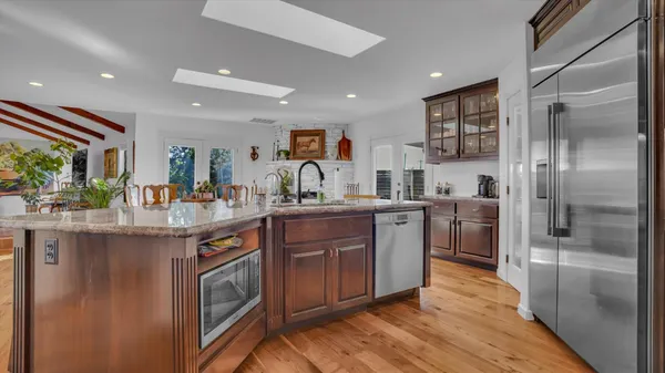 a kitchen with stainless steel appliances granite countertop a stove and a refrigerator