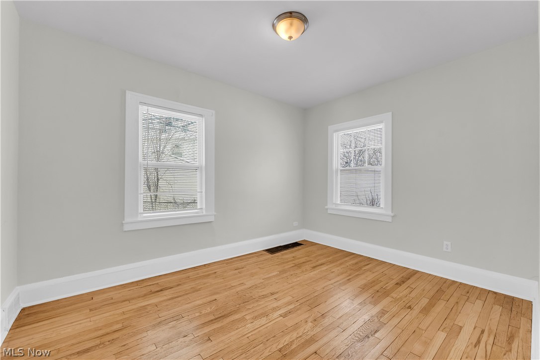 3318 Milverton Road, Unit 1/DN Shaker Heights, OH 44120 - Photo 14 of 21 Room featuring light hardwood floors, light gray walls, white trim, and two windows