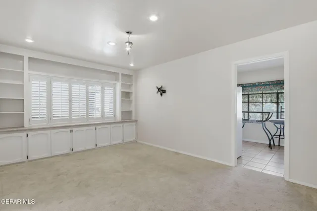 a living room with furniture a flat screen tv and a large window