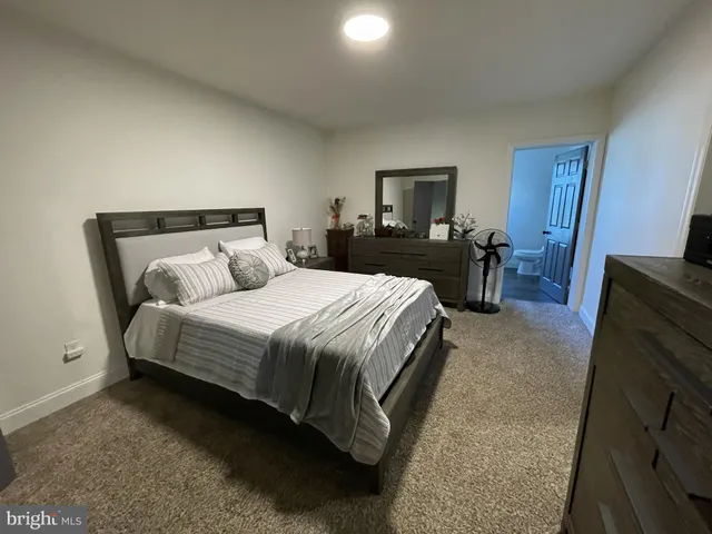 a bedroom with a bed and a tv on table