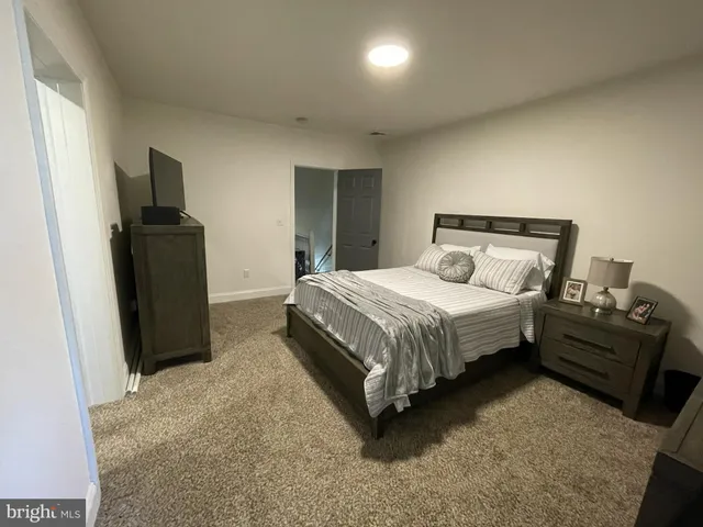 a bedroom with a bed and a television