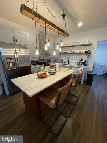 a kitchen with a sink a stove and chairs