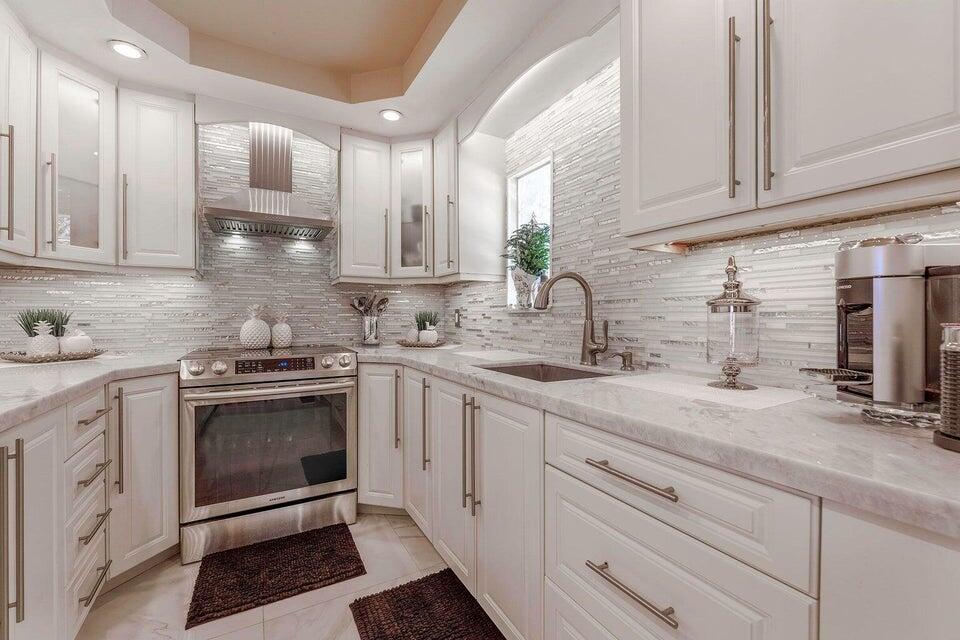 2935 Lake Worth Road Palm Springs, FL 33461 - Photo 11 of 22 a kitchen with a sink stove and cabinets