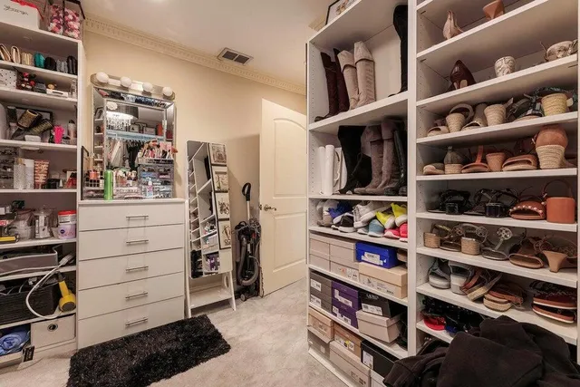a bathroom with a granite countertop sink mirror vanity and toilet