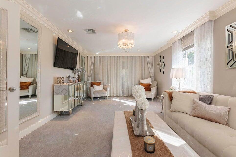 2935 Lake Worth Road Palm Springs, FL 33461 - Photo 7 of 22 a living room with furniture and a flat screen tv