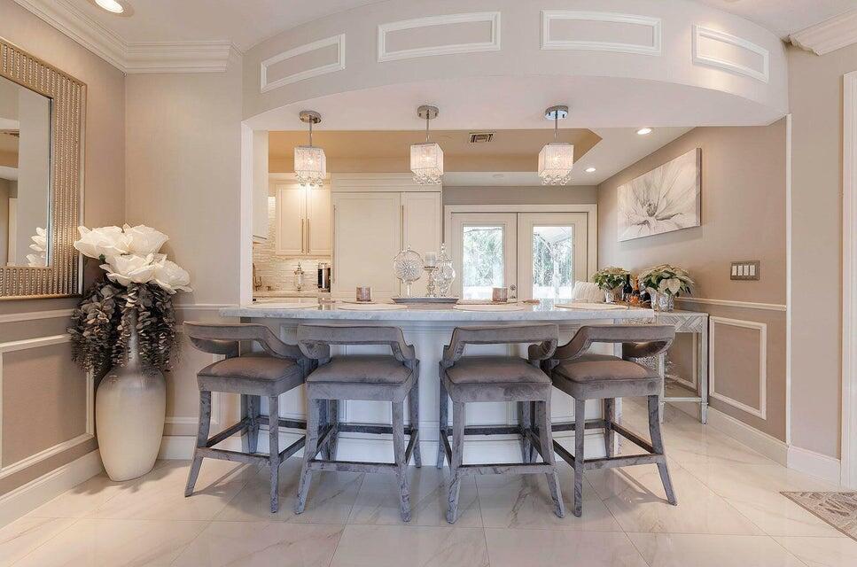 2935 Lake Worth Road Palm Springs, FL 33461 - Photo 9 of 22 a dining room filled chandelier and kitchen view