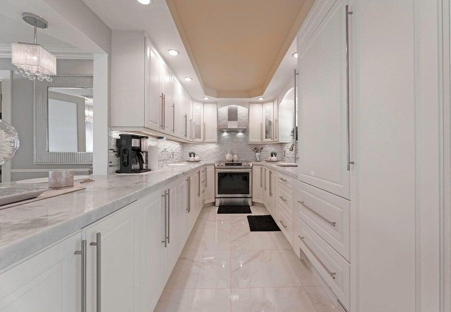 2935 Lake Worth Road Palm Springs, FL 33461 - Photo 10 of 22 a kitchen with white cabinets and white appliances