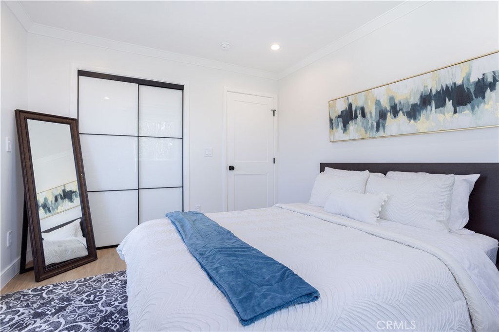 19429 Singing Hills Drive Porter Ranch, CA 91326 - Photo 15 of 26 a bedroom with a bed and painting on the wall