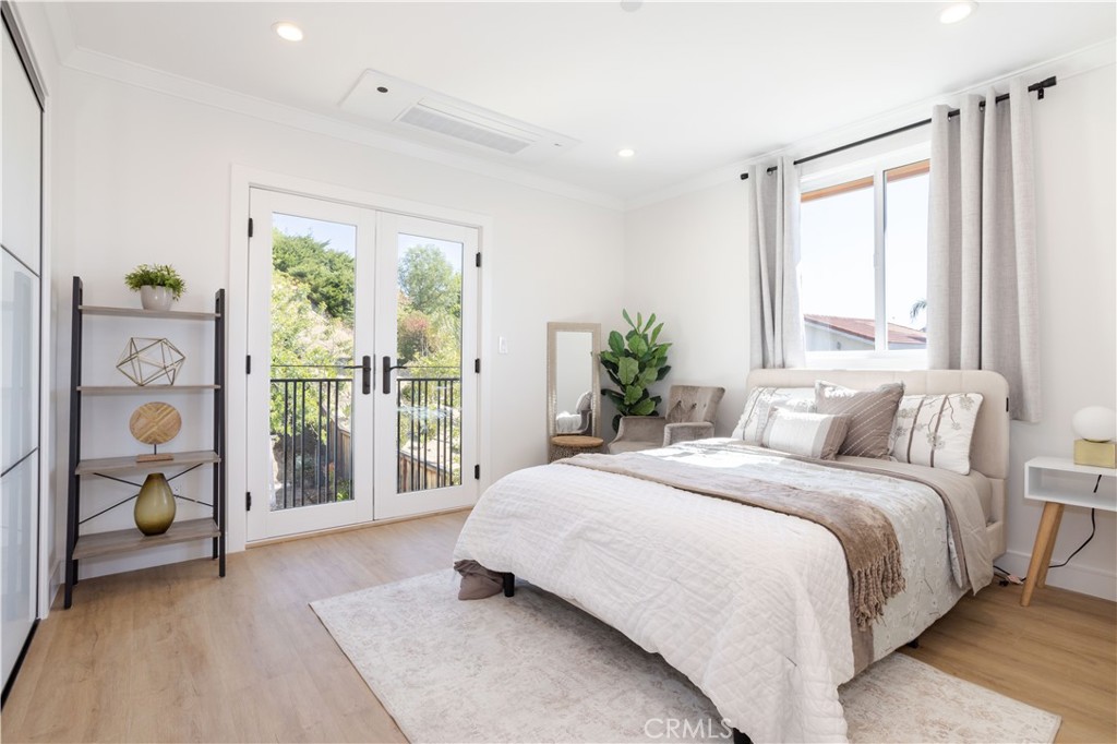 19429 Singing Hills Drive Porter Ranch, CA 91326 - Photo 20 of 26 a bedroom with a large bed and a potted plant