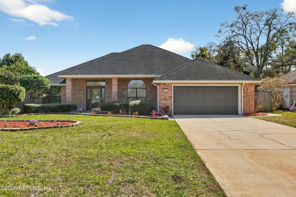 a view of a house with swimming pool and a yard