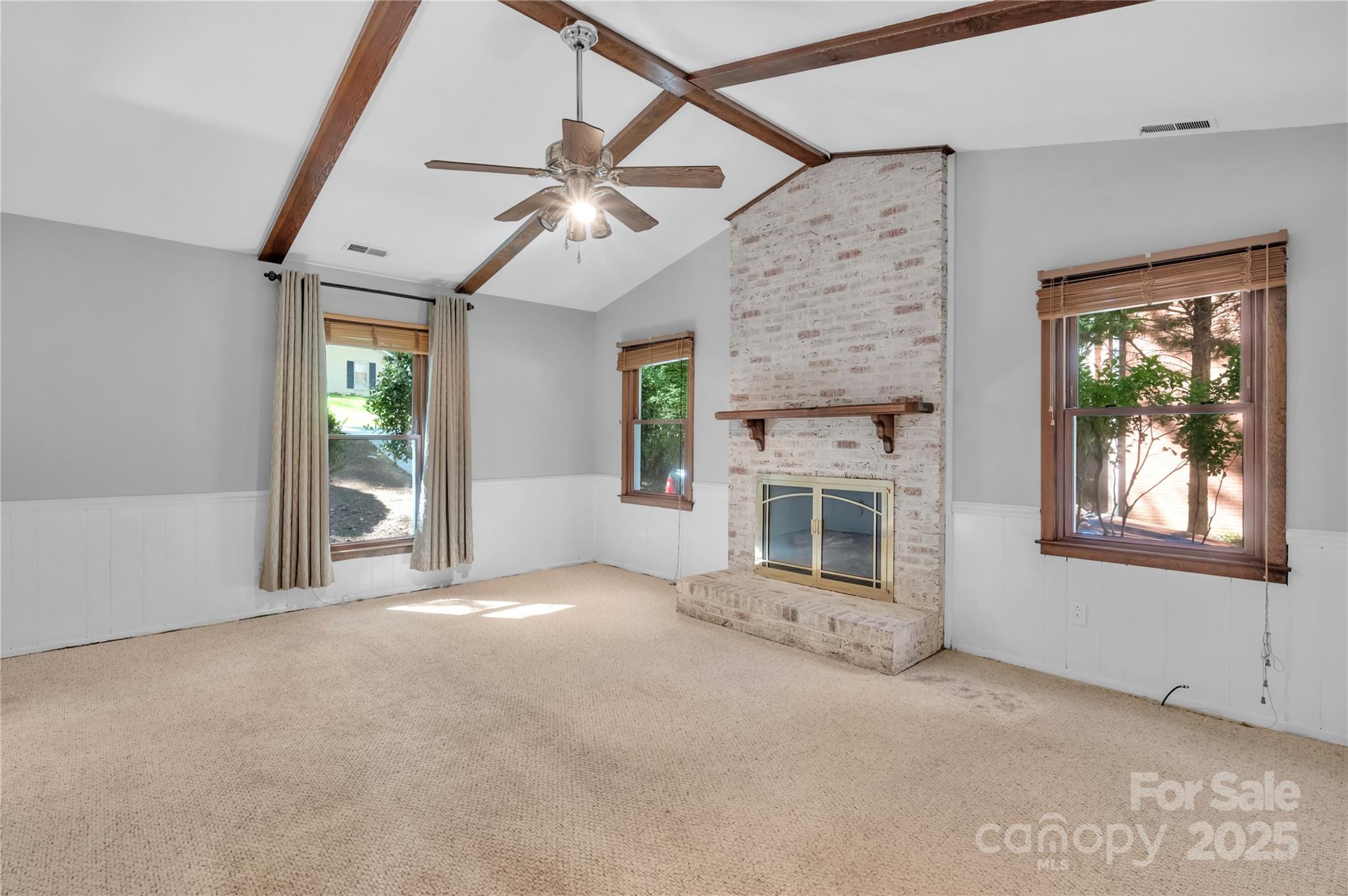 702 Trail Ridge Road Matthews, NC 28105 - Photo 2 of 36 an empty room with windows and fireplace