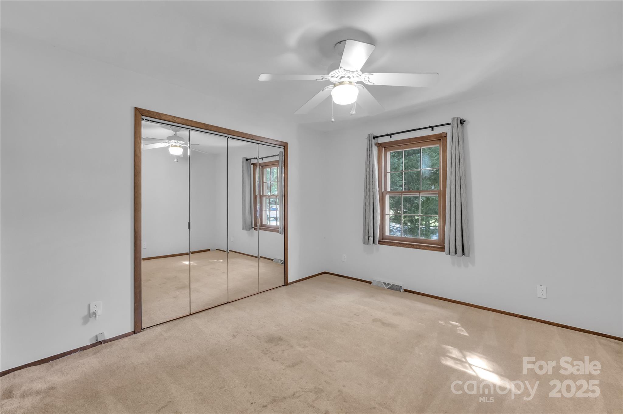 702 Trail Ridge Road Matthews, NC 28105 - Photo 24 of 36 an empty room with windows and fan
