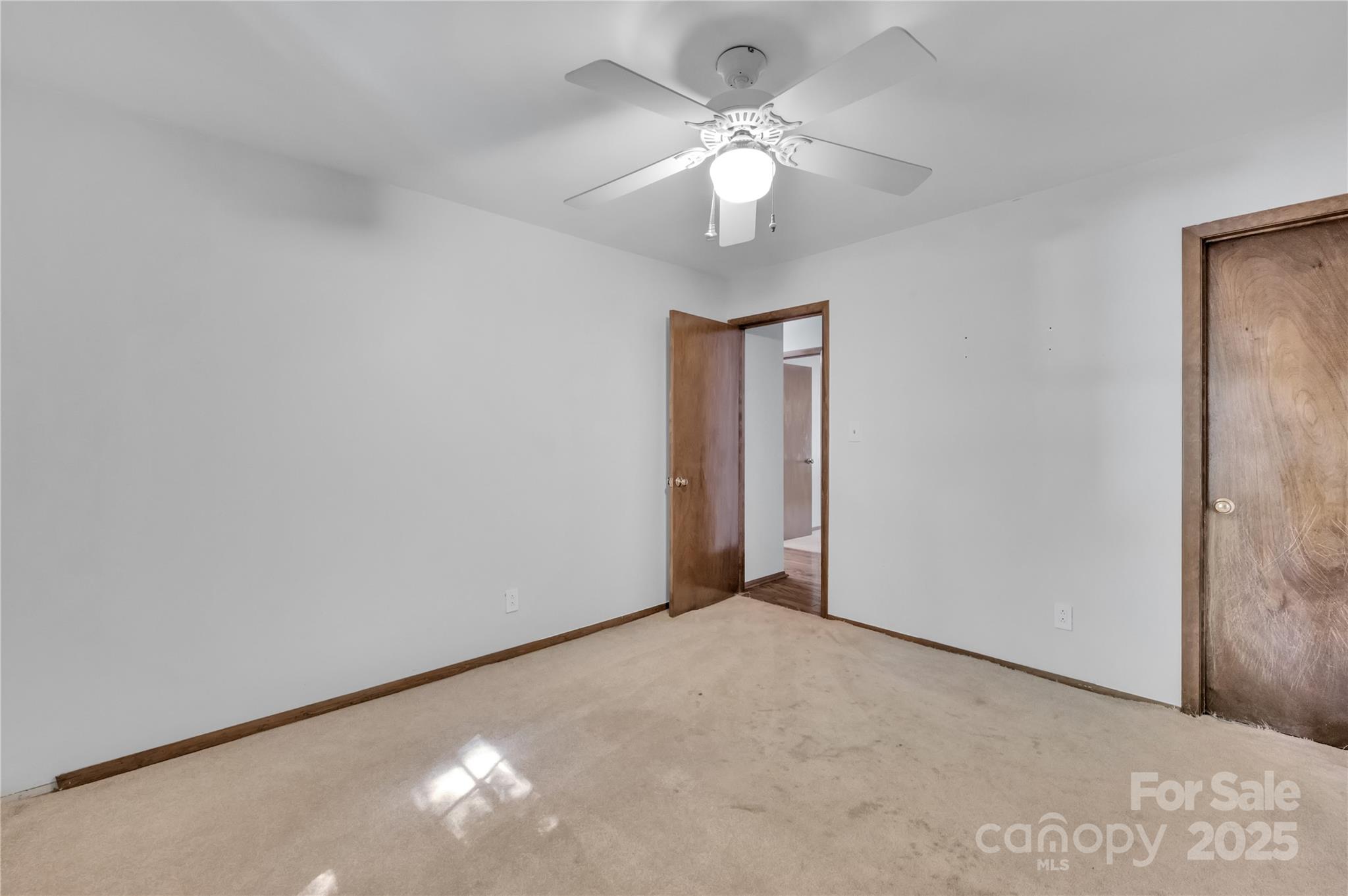 702 Trail Ridge Road Matthews, NC 28105 - Photo 25 of 36 a view of an empty room with a chandelier fan
