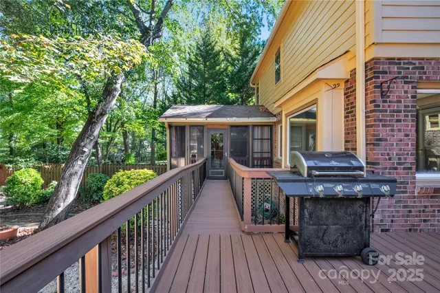 a view of a wooden chairs on the roof deck