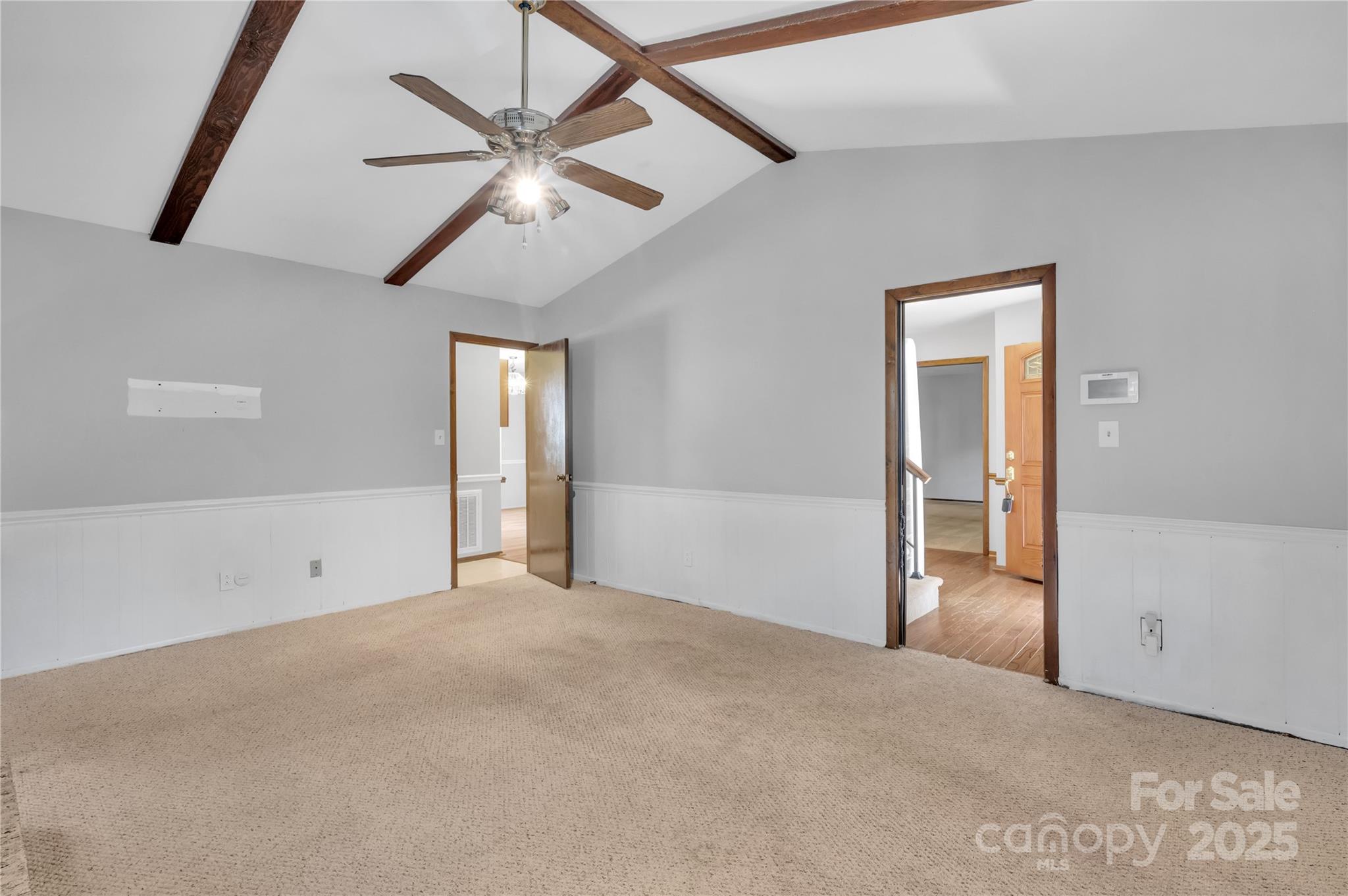 702 Trail Ridge Road Matthews, NC 28105 - Photo 3 of 36 en empty room with ceiling fan and window