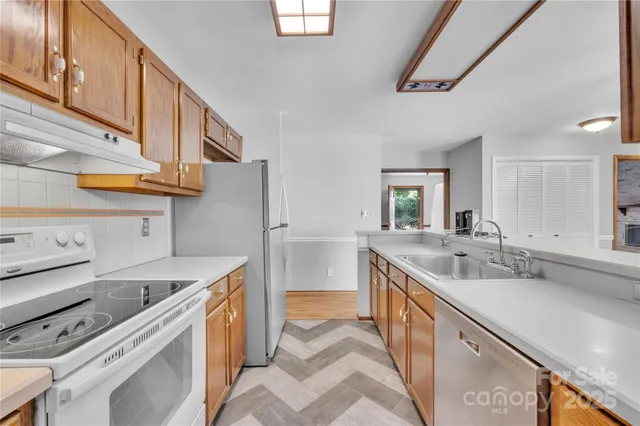 a kitchen with a sink stove and cabinets
