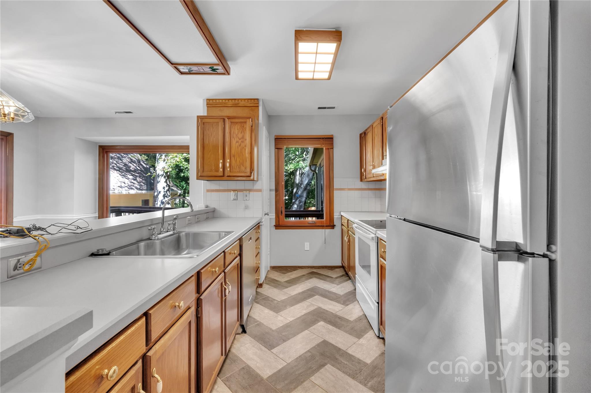 702 Trail Ridge Road Matthews, NC 28105 - Photo 5 of 36 a kitchen with a refrigerator and a sink