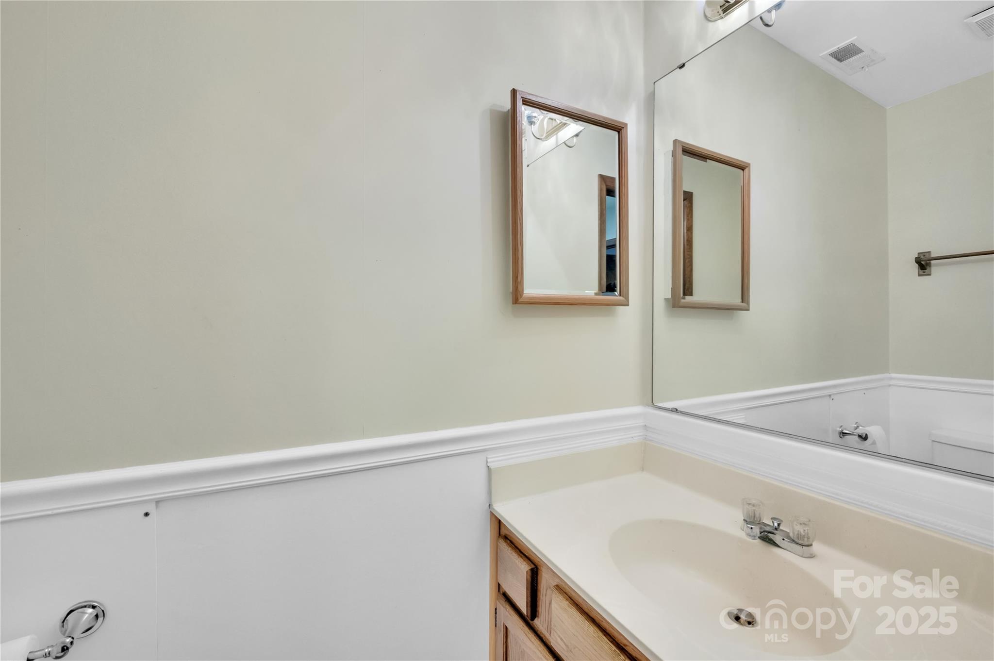 702 Trail Ridge Road Matthews, NC 28105 - Photo 10 of 36 a bathroom with a sink and a mirror