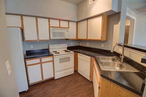 a kitchen with a sink stove and cabinets