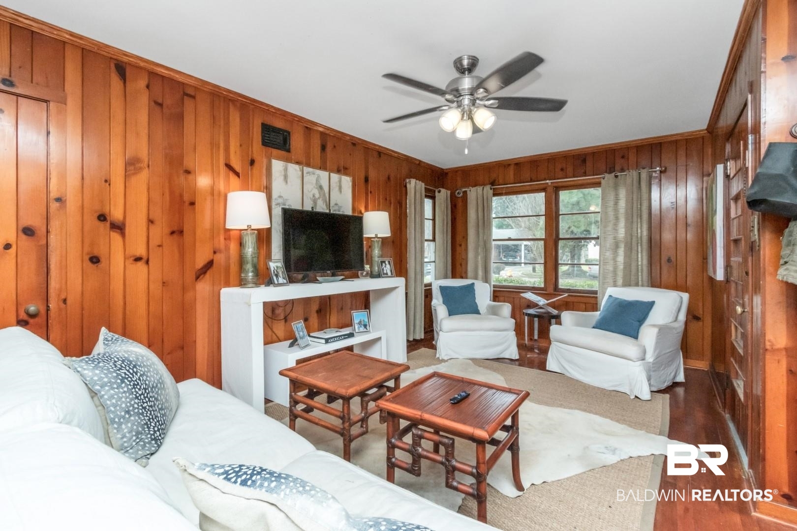 20 Kirby Street Mobile, AL 36607 - Photo 9 of 35 Living room featuring ceiling fan, wood walls, dark hardwood / wood-style flooring, and ornamental molding