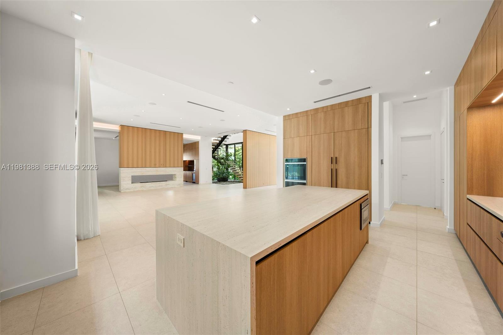 7700 Southwest 50th Court Miami, FL 33143 - Photo 24 of 62 a large white kitchen with a refrigerator a sink and a large window