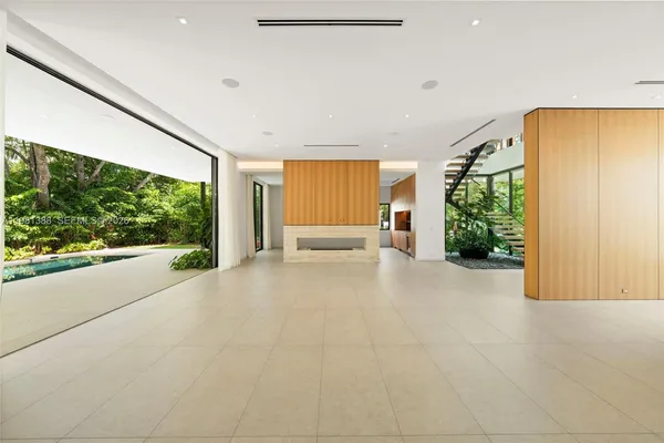 a view of staircase with railing and white walls