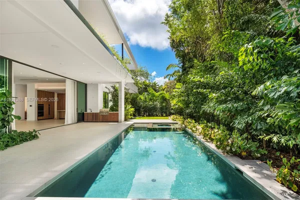 a spacious bathroom with a double vanity sink a large mirror and a shower