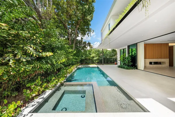 a large spacious bathroom with a double vanity sink and mirror