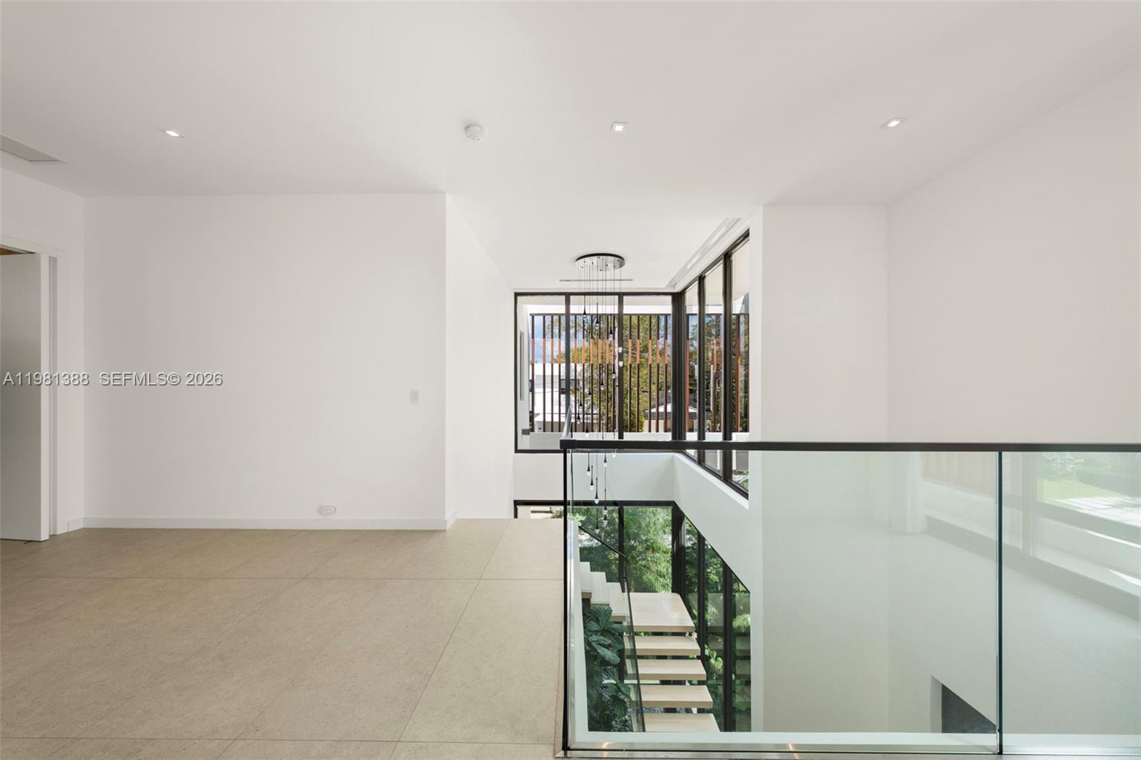 7700 Southwest 50th Court Miami, FL 33143 - Photo 36 of 62 a view of staircase with railing and white walls