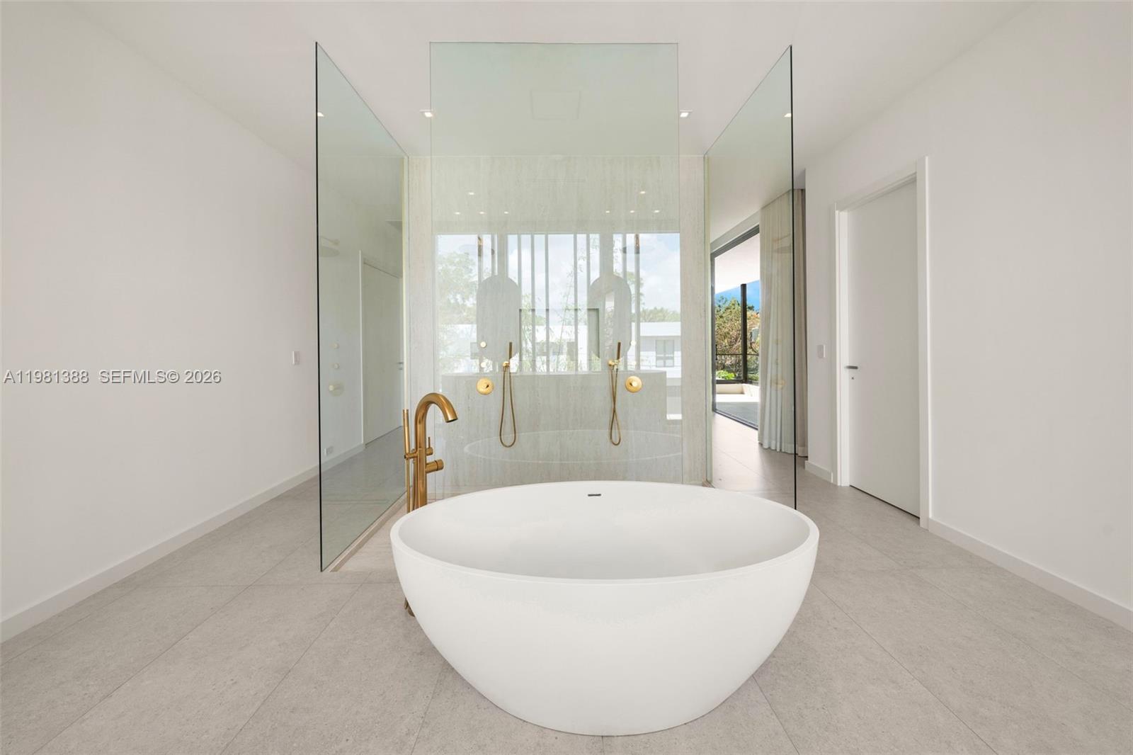 7700 Southwest 50th Court Miami, FL 33143 - Photo 44 of 62 a bathroom with a bathtub and a chandelier