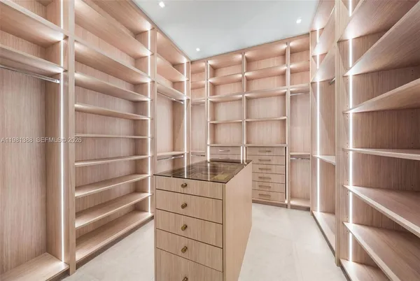 a bathroom with a tub sink mirror and a shower