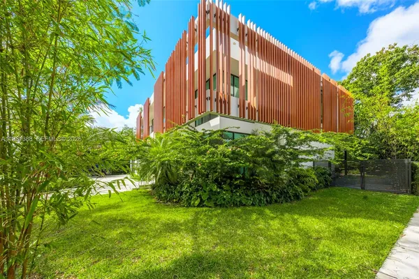 a aerial view of a house with a yard and potted plants