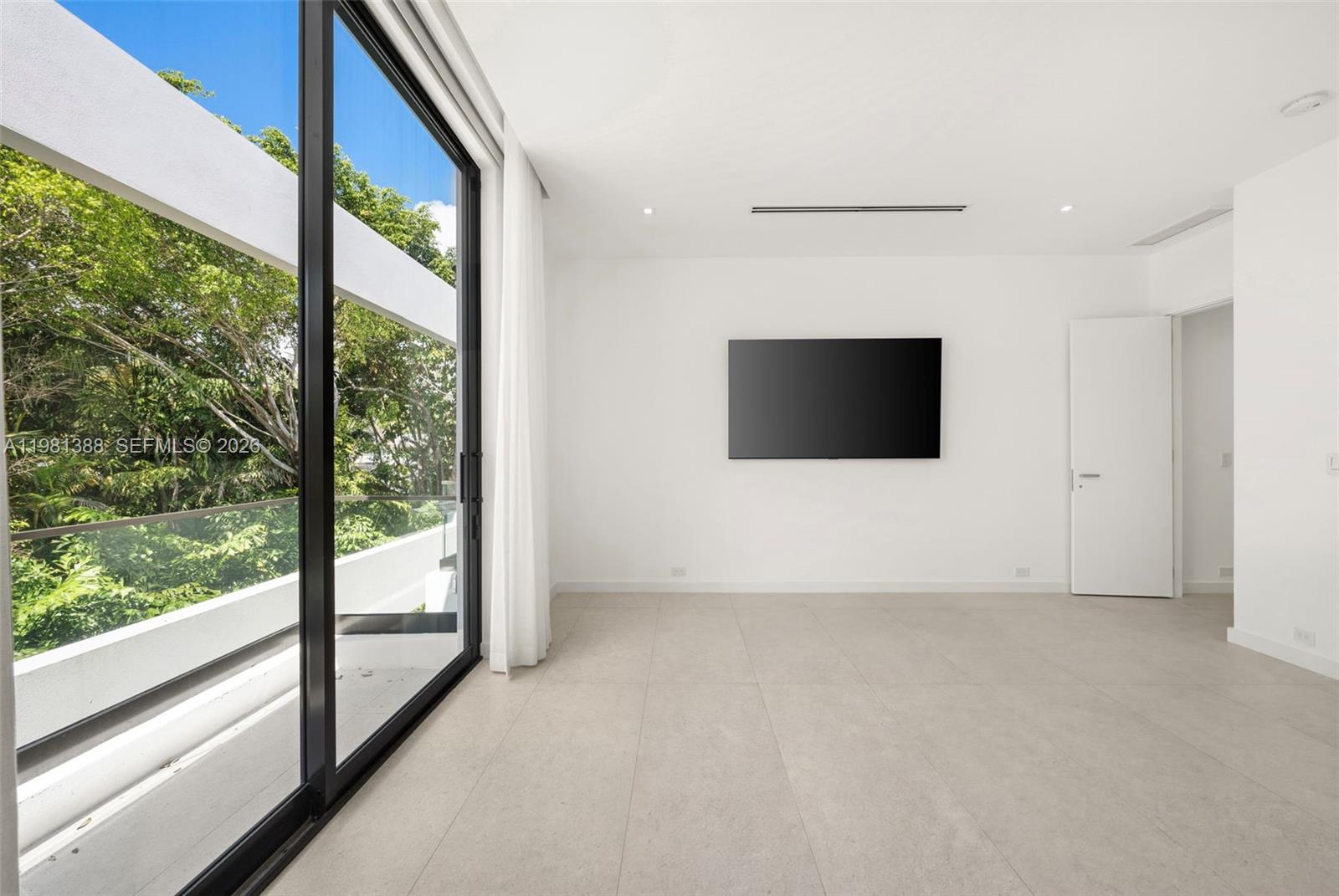 7700 Southwest 50th Court Miami, FL 33143 - Photo 51 of 62 a view of an empty room with a flat screen tv