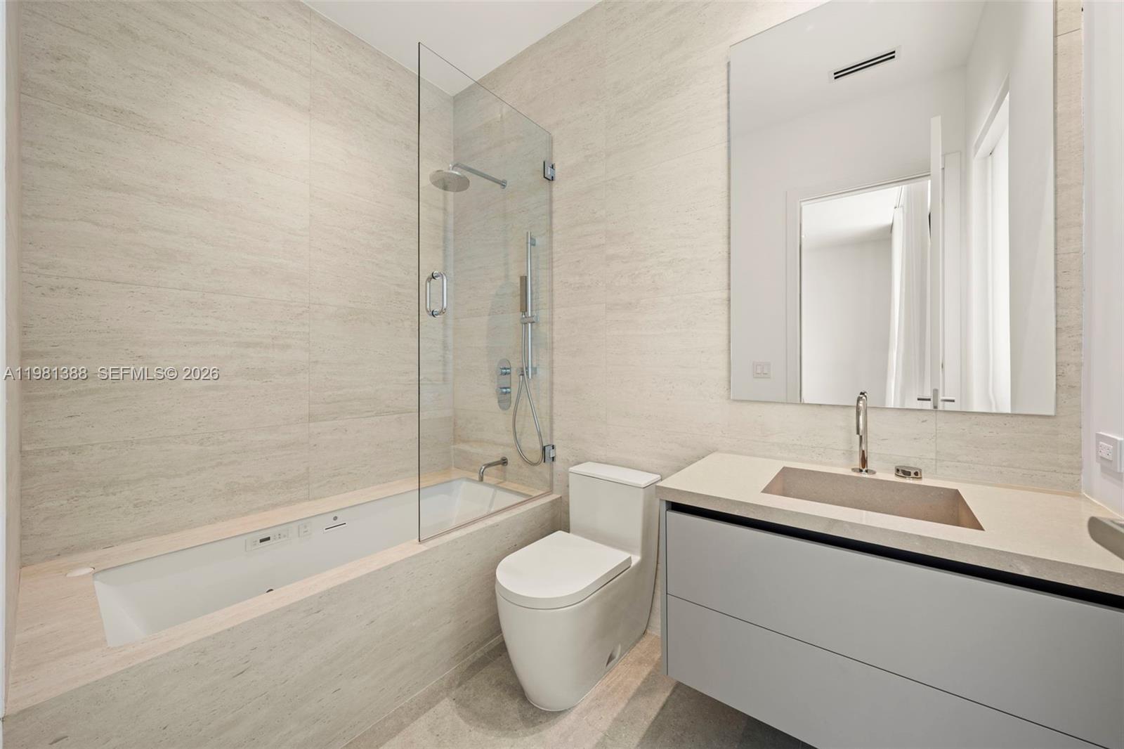 7700 Southwest 50th Court Miami, FL 33143 - Photo 52 of 62 a bathroom with a toilet a sink and a bathtub