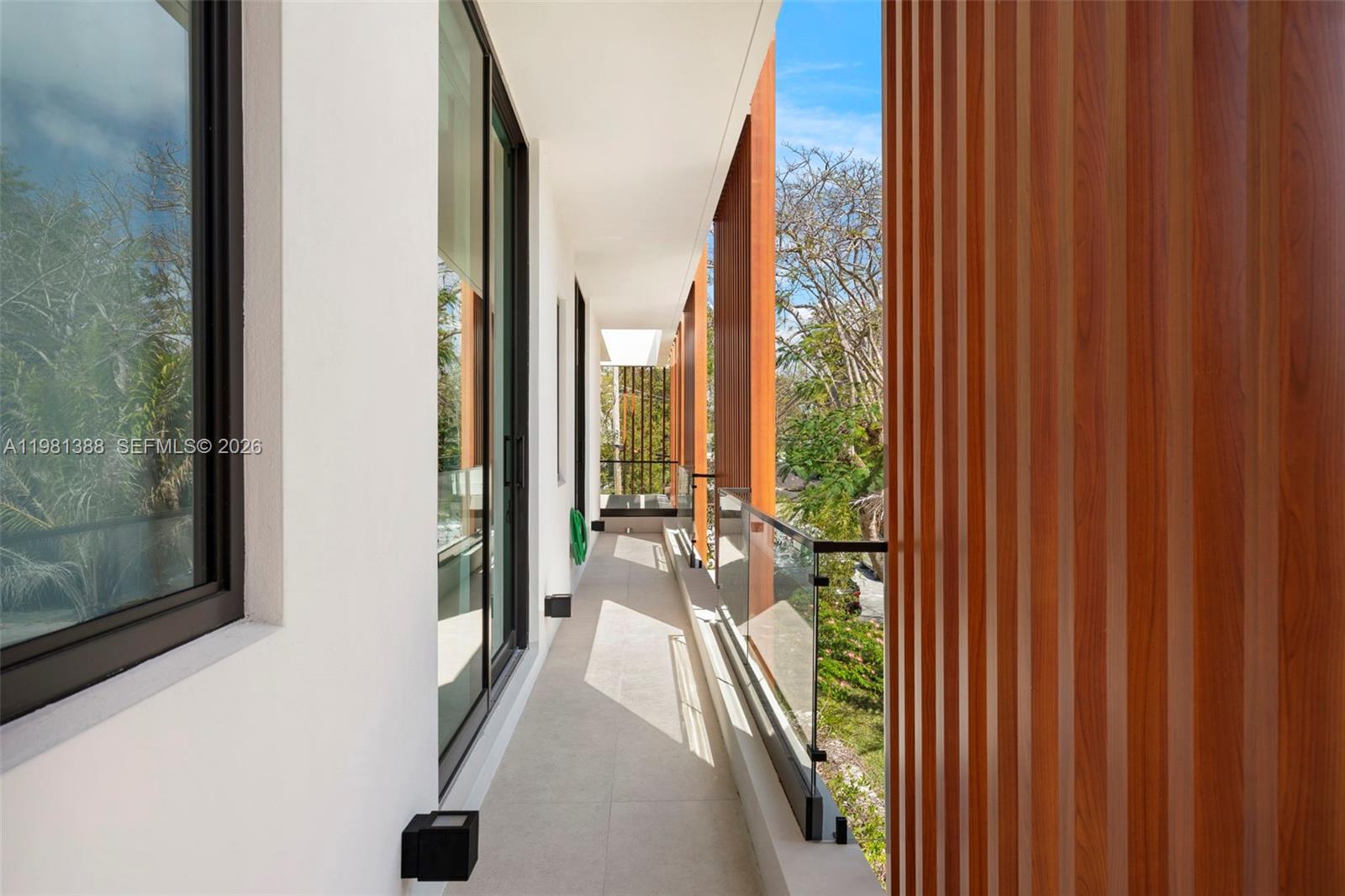 7700 Southwest 50th Court Miami, FL 33143 - Photo 54 of 62 a view of a balcony with wooden floor and outdoor space