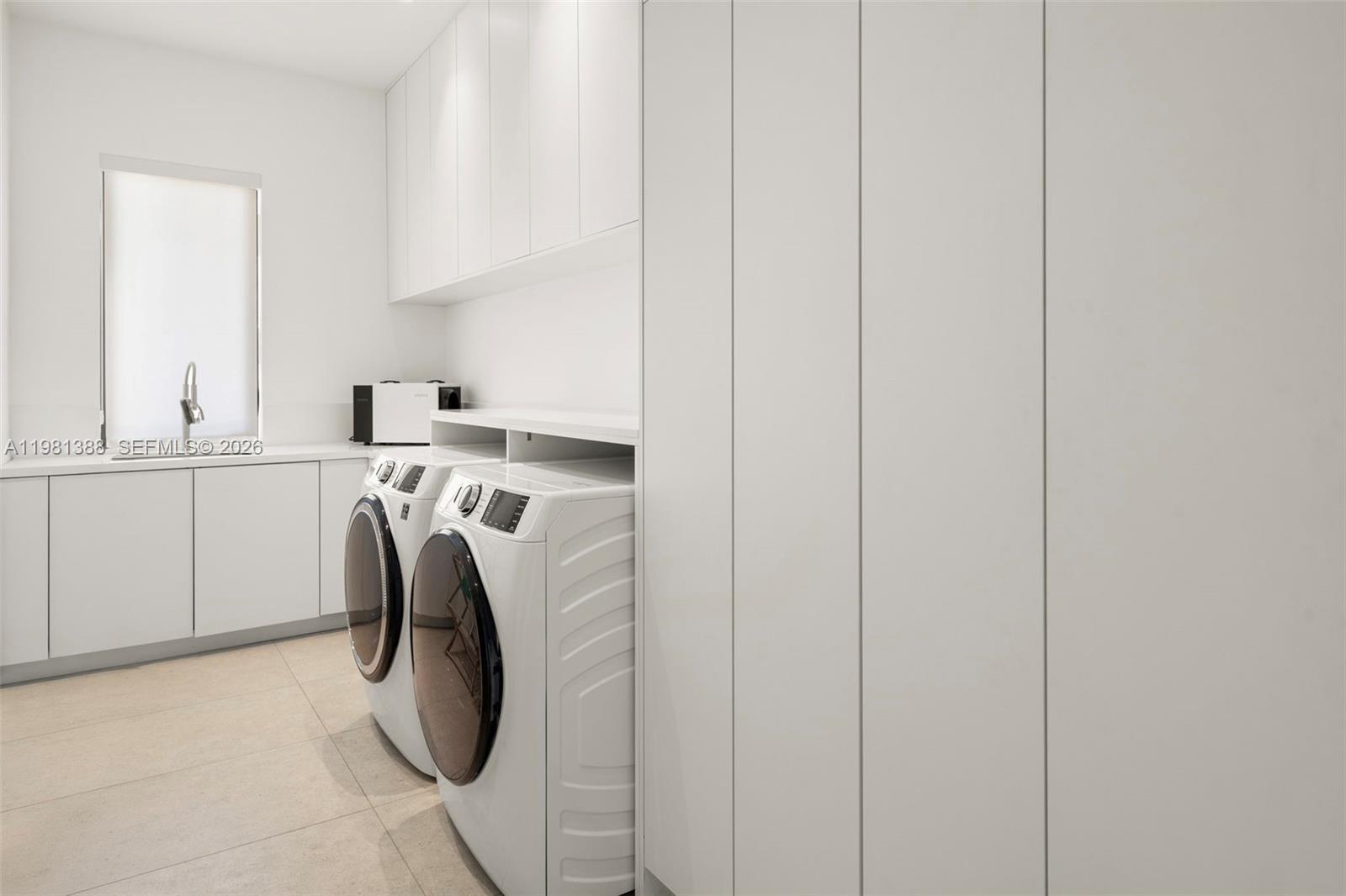 7700 Southwest 50th Court Miami, FL 33143 - Photo 57 of 62 a utility room with dryer and washer