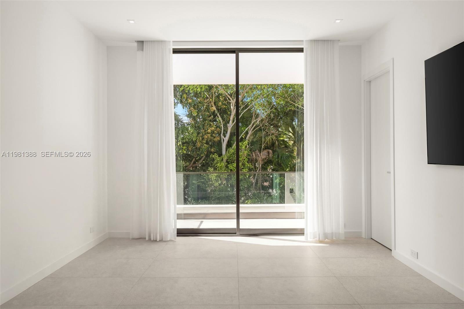 7700 Southwest 50th Court Miami, FL 33143 - Photo 58 of 62 a view of an empty room with a window