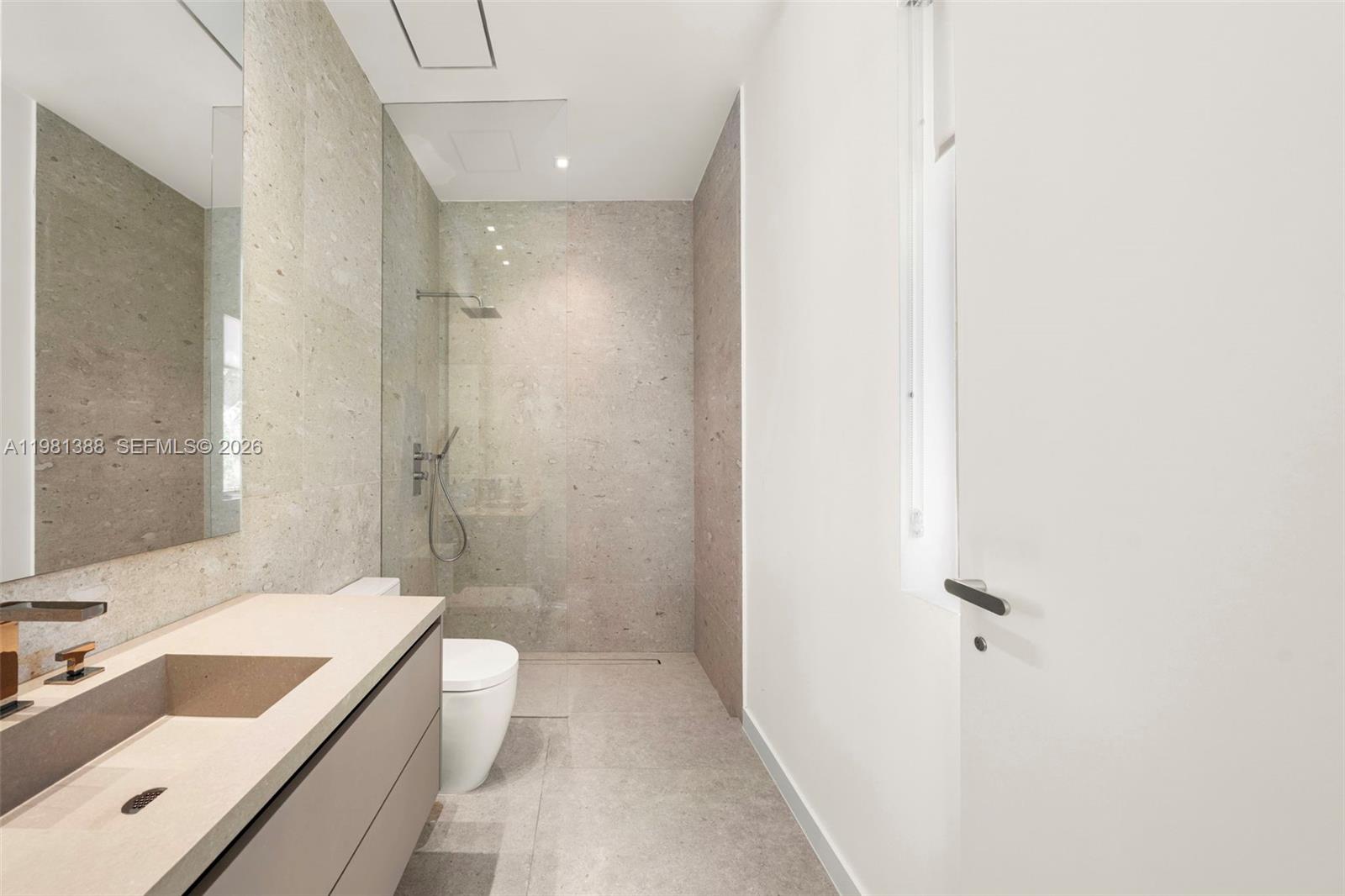 7700 Southwest 50th Court Miami, FL 33143 - Photo 59 of 62 a bathroom with a tub sink mirror and a shower
