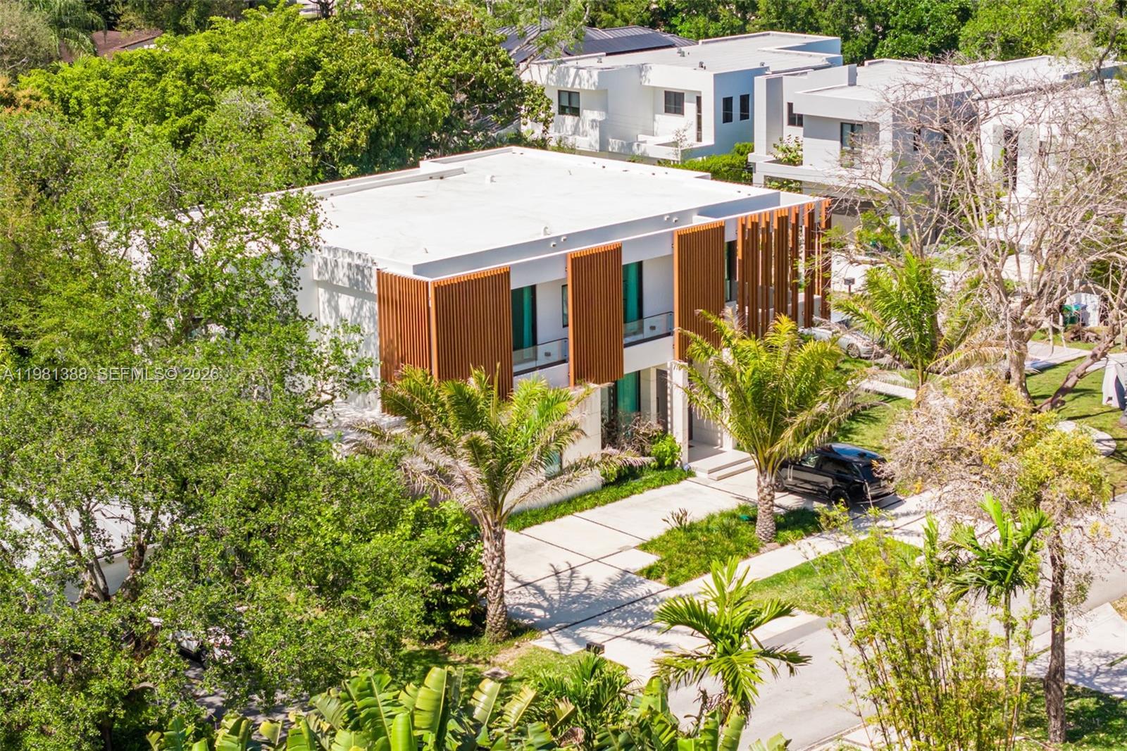 7700 Southwest 50th Court Miami, FL 33143 - Photo 7 of 62 a aerial view of a house with a yard and potted plants