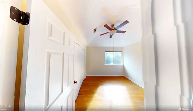 a view of a room with wooden floor