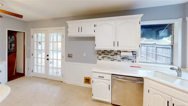 a kitchen with cabinets and window