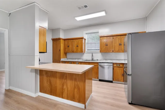 a kitchen with stainless steel appliances granite countertop a sink and stove top oven