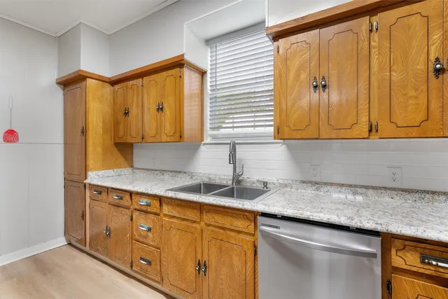 a kitchen with a sink cabinets and a window