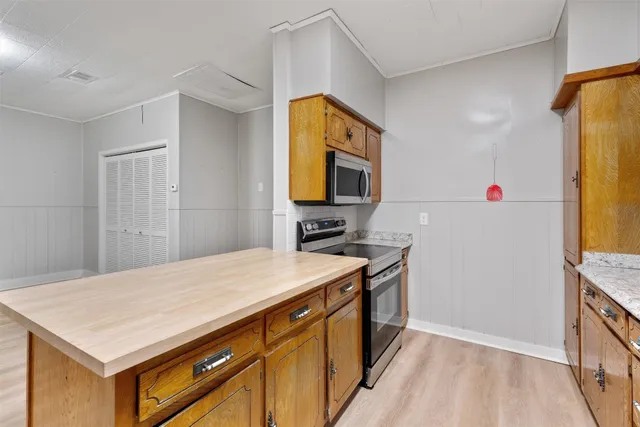 a kitchen that has a sink and a stove in it