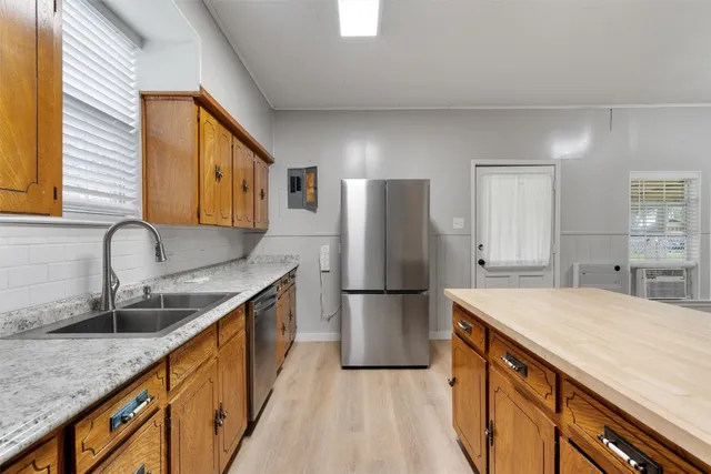 a kitchen with refrigerator cabinets and a sink