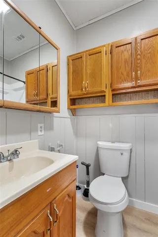 a bathroom with a sink a toilet and mirror