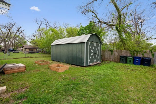 a backyard of a house with table and chairs