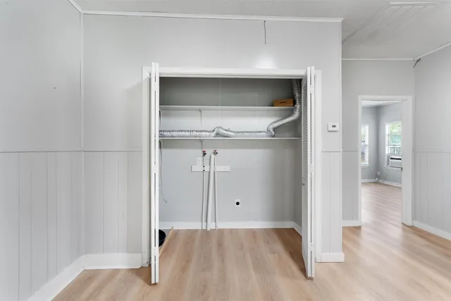 a view of empty room with wooden floor