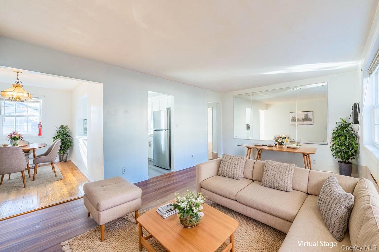 222-17 69th Avenue, Unit 17A Queens, NY 11364 - Photo 2 of 10 a living room with furniture and a wooden floor