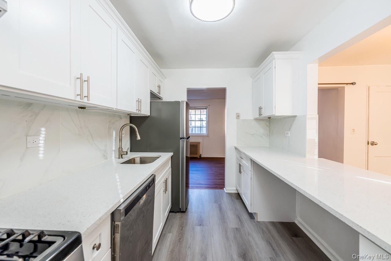 222-17 69th Avenue, Unit 17A Queens, NY 11364 - Photo 5 of 10 a kitchen with a sink stove top oven and cabinets